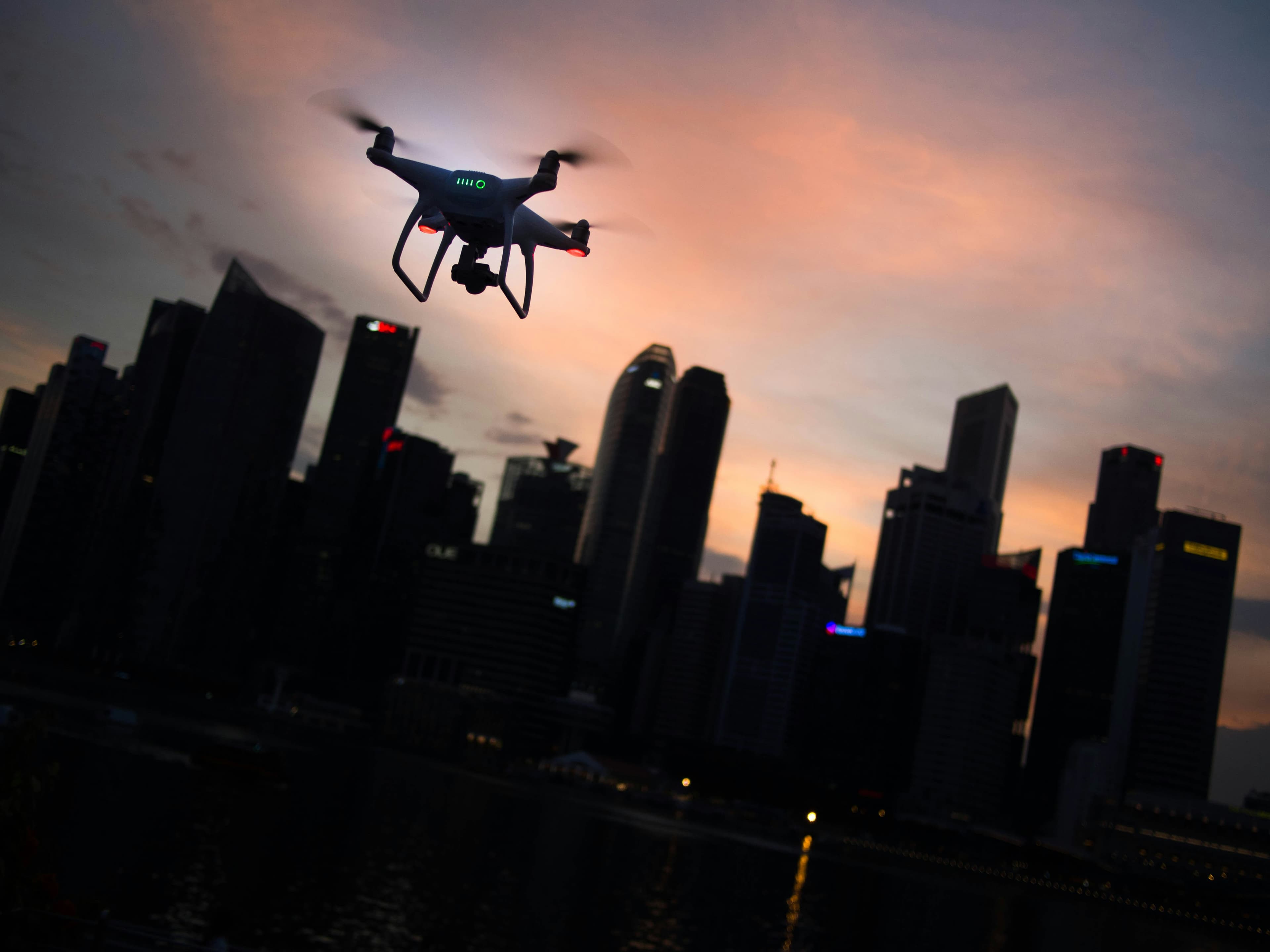 Cinematic dusk drone shot over a city skyline