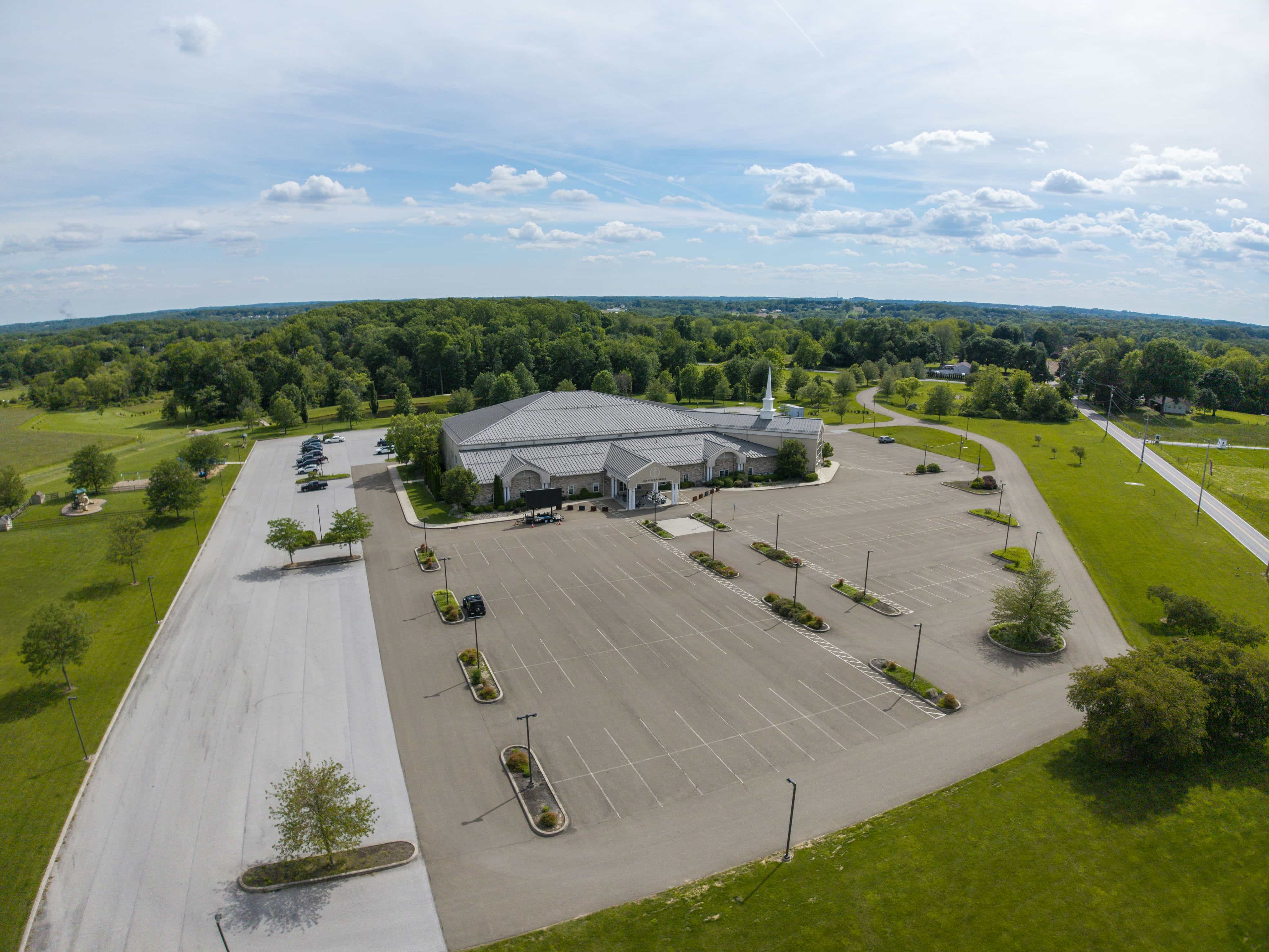 Aerial view of a commercial building and parking lot